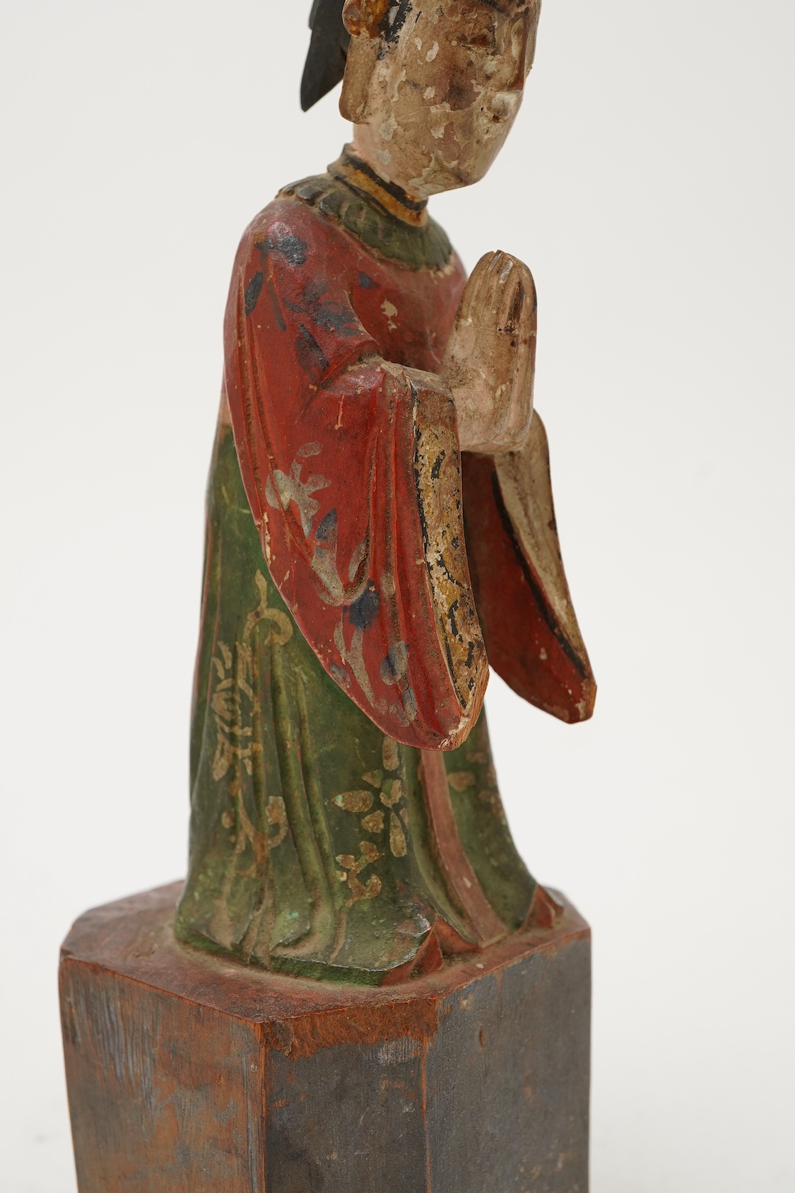 A Chinese polychrome wood figure of a female attendant, Qing dynasty